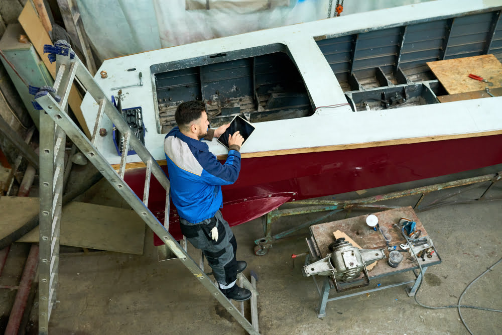 man repairing yacht
